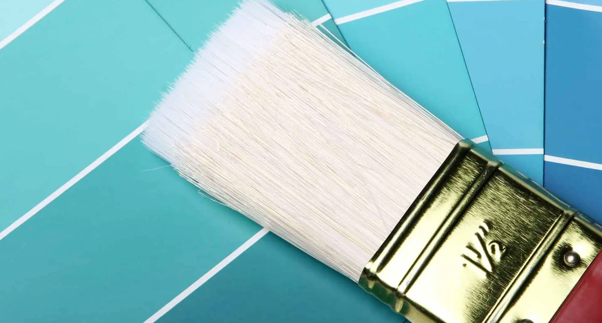 Choosing the perfect teal shade of interior paint with paintbrush and color samples.