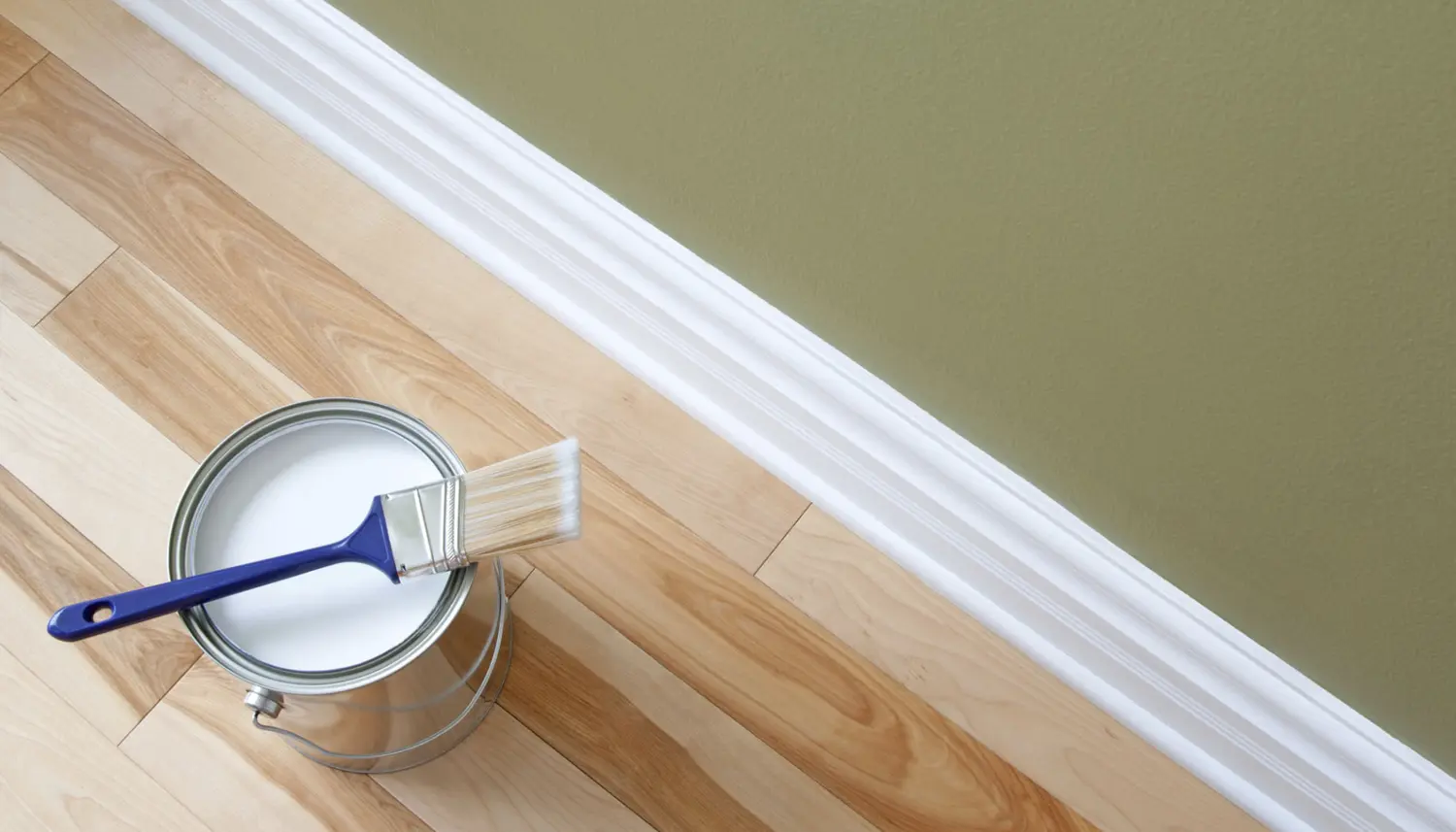 Quality interior residential painting service in Savannah, readying paint for baseboards and walls.